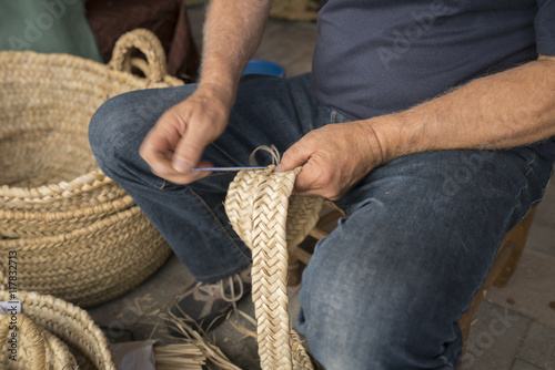 hand man weaving a wicker basket © bykofoto