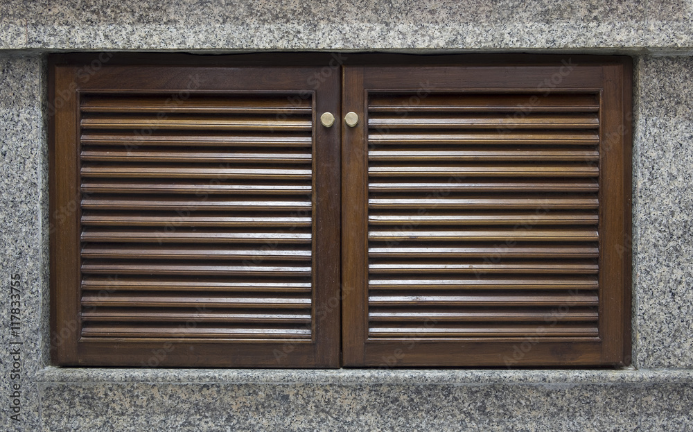 Wooden door and window shutter with louvers for background textu