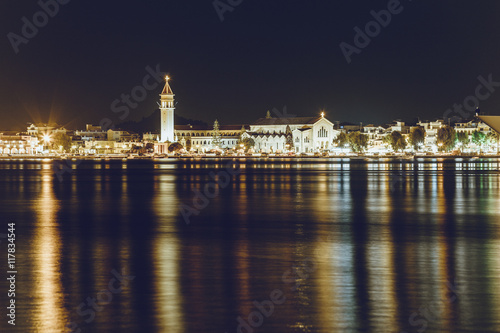 Night view of city of Zakynthos, the city lights reflected in the sea water, Greece