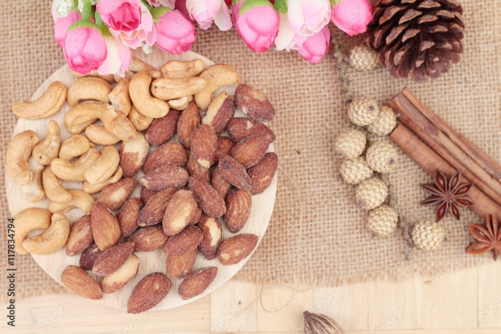 Almonds and cashew is delicious on wood background. Almonds and cashew is delicious on wood background.