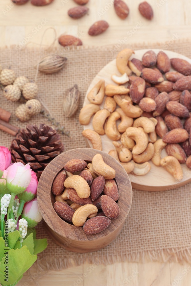 Almonds and cashew is delicious on wood background. Almonds and cashew is delicious on wood background.