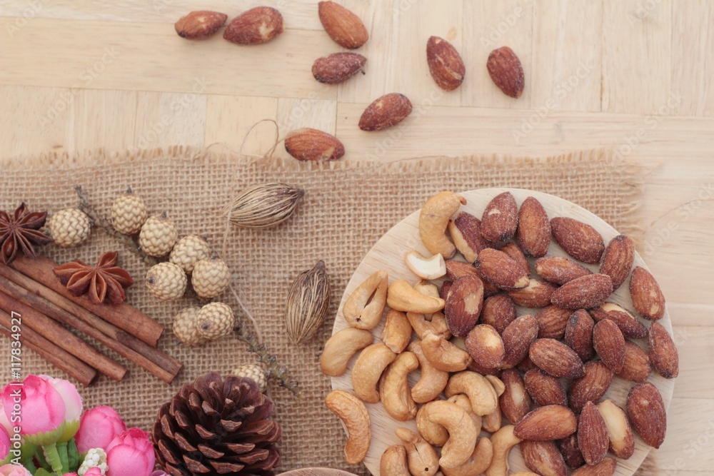 Almonds and cashew is delicious on wood background. Almonds and cashew is delicious on wood background.