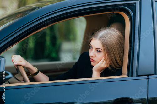 Girl borred in her car in traffic jam photo