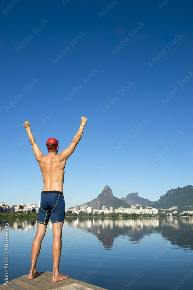 Athlete swimmer standing in front of the Rio de Janeiro skyline at Lagoa Rodrigo de Freitas lagoon Athlete swimmer standing in front of the Rio de Janeiro skyline at Lagoa Rodrigo de Freitas lagoon
