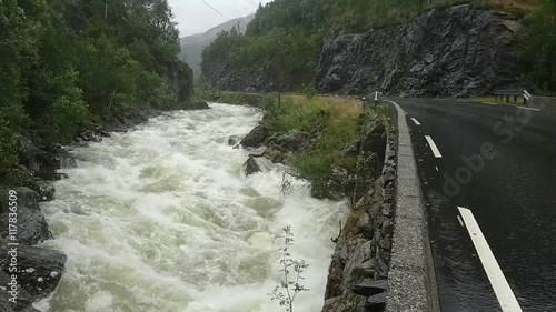 Large river beside a road in the mountains of Norway photo