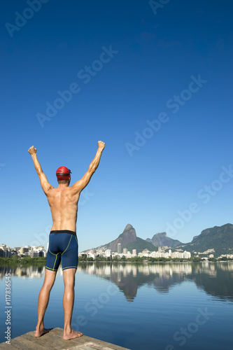 Athlete swimmer standing in front of the Rio de Janeiro skyline at Lagoa Rodrigo de Freitas lagoon
