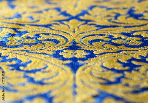 A blue and gold silk texture with arabesque, suitable to be use like a background