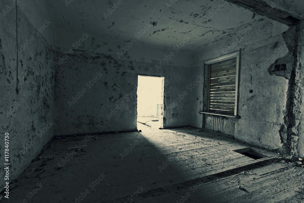 Dark room in an abandoned ruined house. Grunge texture. Tinted photo. Dark room in an abandoned ruined house. Grunge texture. Tinted photo.
