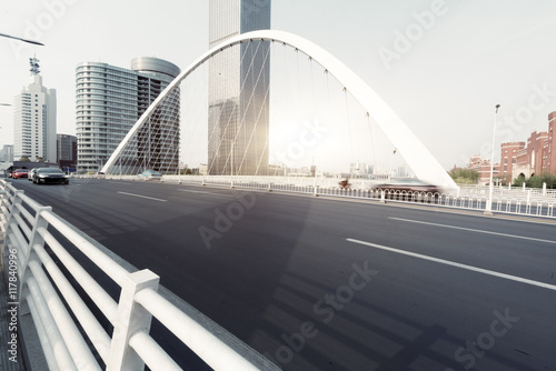 urban traffic on bridge with cityscape in background