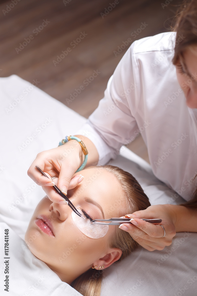 Eyelash Extension Procedure. Woman Eye with Long Eyelashes. Lashes, close up, selected focus. Eyelash Extension Procedure. Woman Eye with Long Eyelashes. Lashes, close up, selected focus.