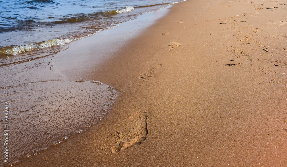 beach, wave and footsteps at sunset time beach, wave and footsteps at sunset time