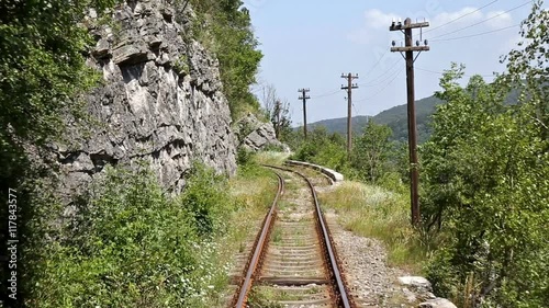 Time lapse with back view of an old mountain railroad. Inaugurated in 1863, it is the oldest mountain railway in Romania. Route between Oravita and Anina. Banat region. photo