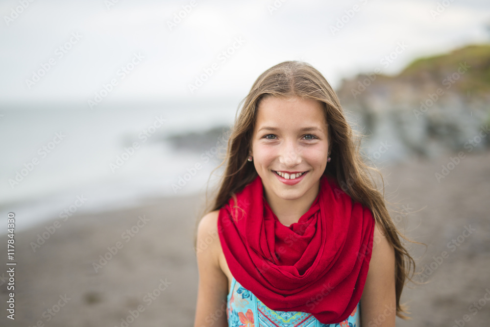 Girl enjoying the rain and having fun outside on the beach a gray rainy Girl enjoying the rain and having fun outside on the beach a gray rainy