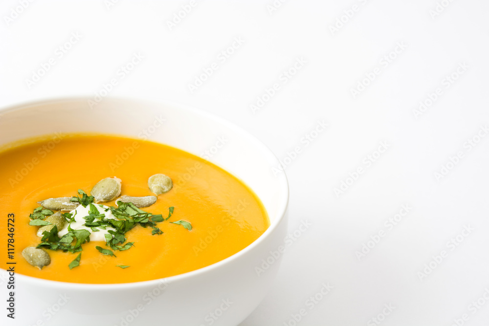 Pumpkin soup with cream and pumpkin seeds isolated on white background
Pumpkin soup with cream and pumpkin seeds isolated on white background