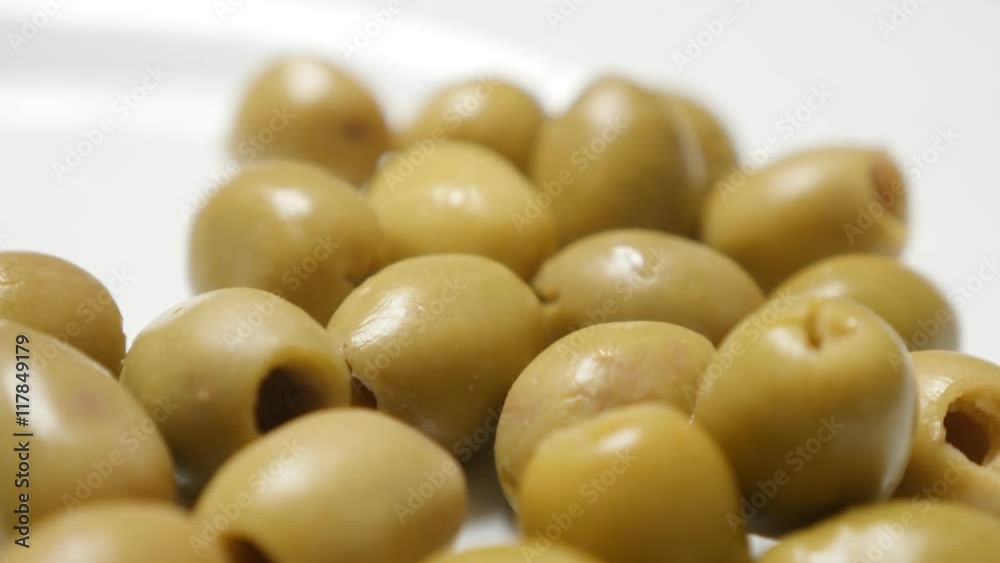 Fermented and marinated green European table olives served on the plate slow tilt 4K 2160p 30fps UltraHD video - Oleae europaea tasty ripe fruit tilting 4K 3840X2160 UHD footage Fermented and marinated green European table olives served on the plate slow tilt 4K 2160p 30fps UltraHD video - Oleae europaea tasty ripe fruit tilting 4K 3840X2160 UHD footage
