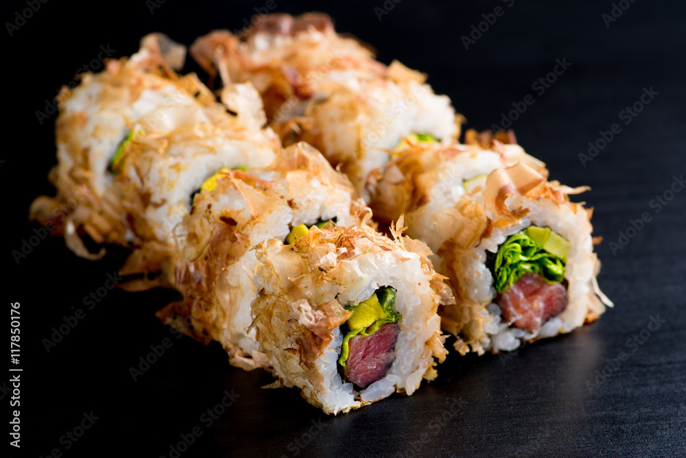 Japanese rolls with fish on a black background Japanese rolls with fish on a black background