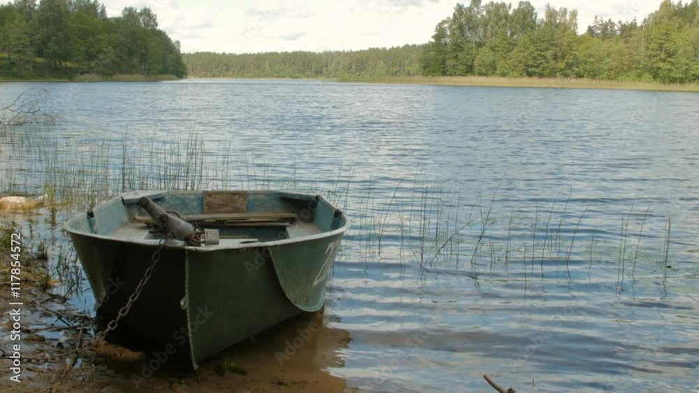 Boat locked with a chain in the lake Boat locked with a chain in the lake