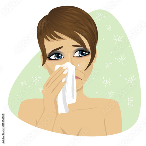 Woman with flu or allergy sneezing into her handkerchief