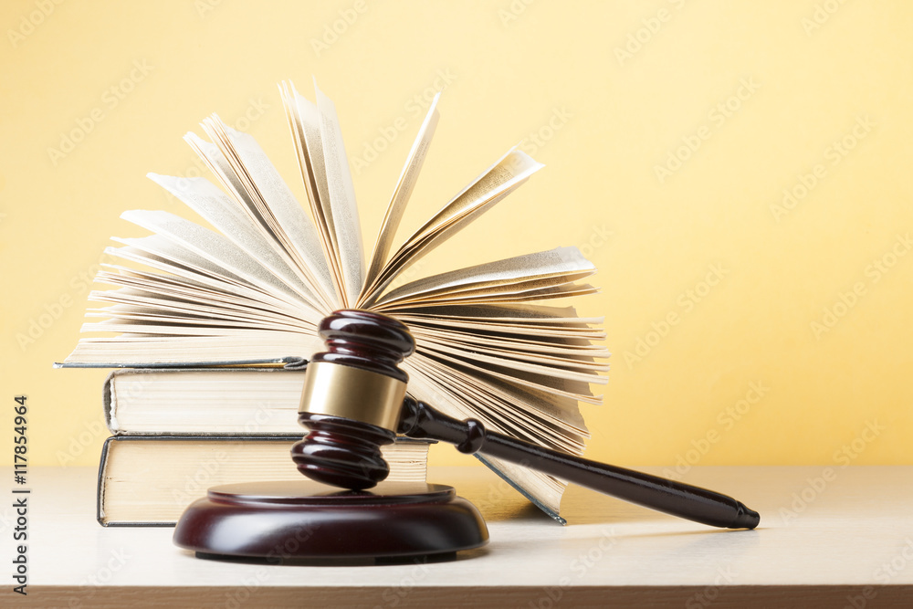 Law concept - Book with wooden judges gavel on table in a courtroom or enforcement office. Law concept - Book with wooden judges gavel on table in a courtroom or enforcement office.