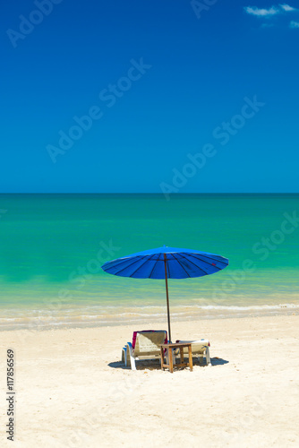 Fototapeta Naklejka Na Ścianę i Meble -  Beach chairs on the sand beach with cloudy blue sky