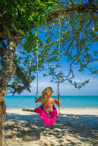 Woman swinging at the beach