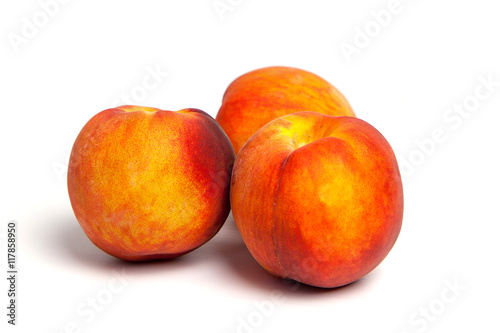 Three peaches on a white background 