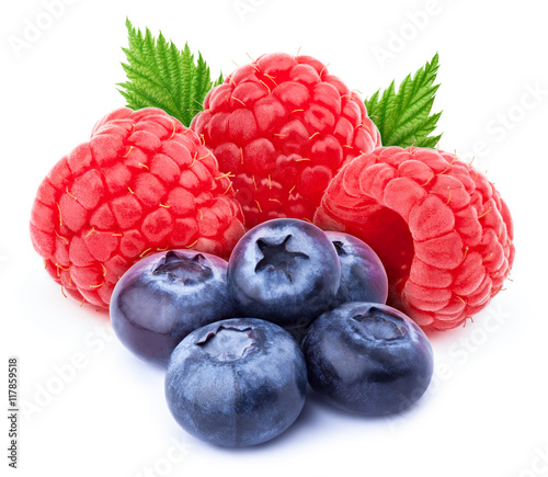 Three ripe raspberries with green leaves and five blueberries isolated on white background with clipping path