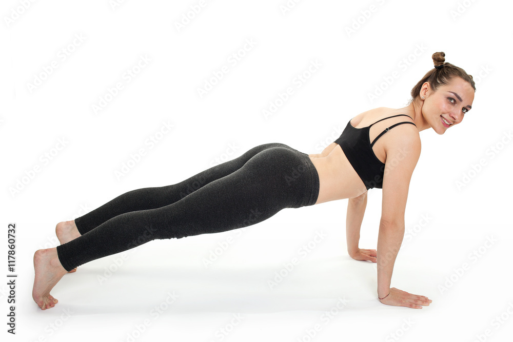 Young brunette woman doing pilates exercises isolated Young brunette woman doing pilates exercises isolated