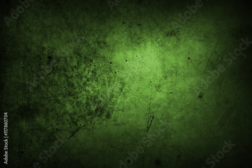 Green grunge concrete stone wall background. Dark edges