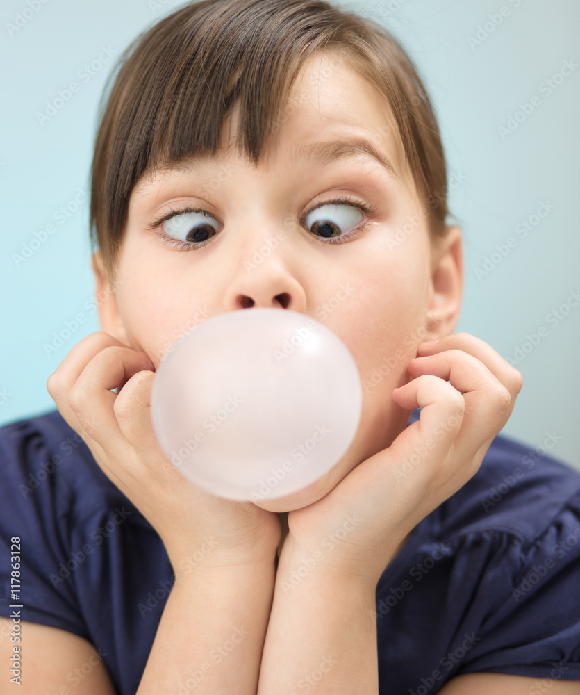 Little girl is blowing big bubble gum Stock Photo Adobe Stock