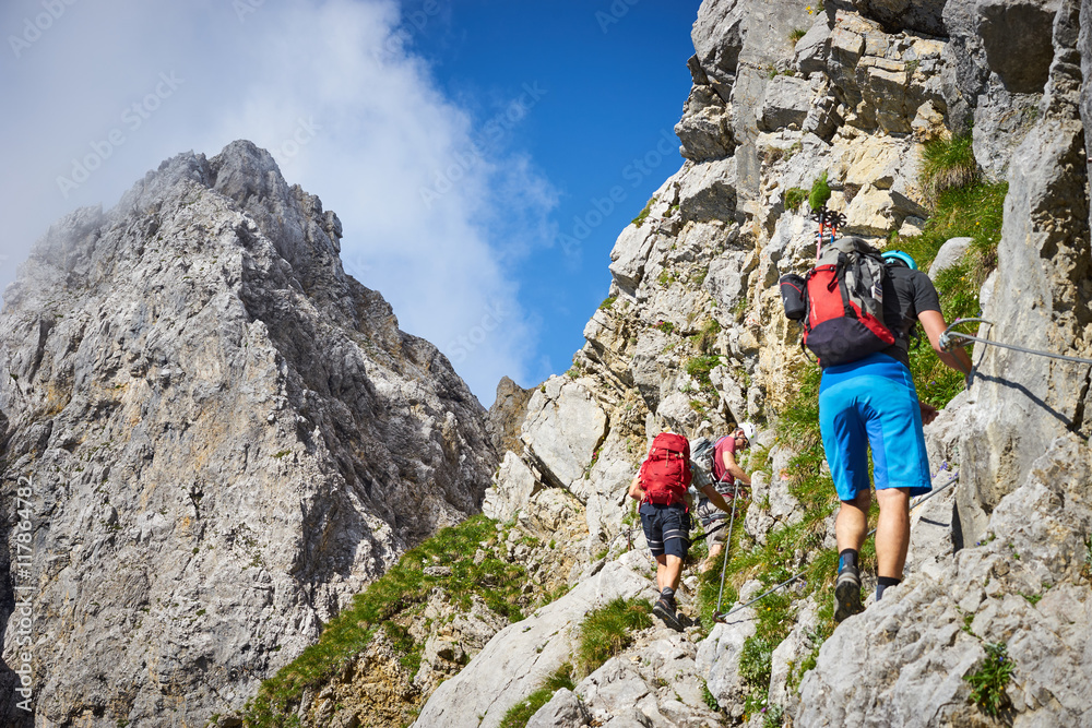 Fototapeta premium mountaineering men / climbing in the alps of Austria at Wilder Kaiser