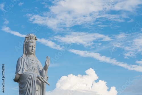 The beautiful statue of Guanyin with blue sky and copy space. - Chinese goddess statue (a public temple , can take picture ) © KissShot