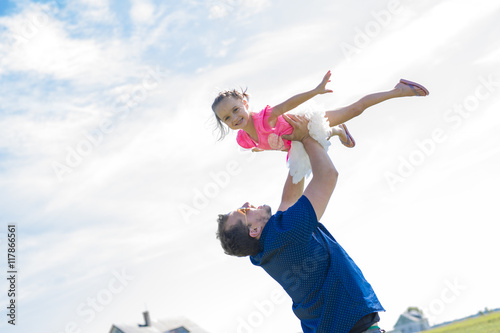 Father with young daughter having fun outside