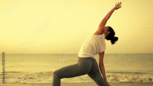 woman practices yoga at the beach photo