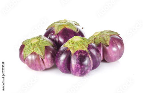 uncooked whole eggplant on white background