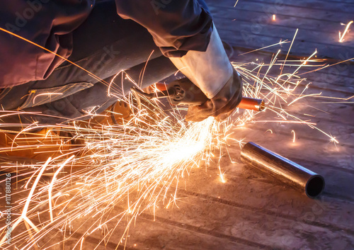 cutting metal with grinder. Sparks while grinding iron