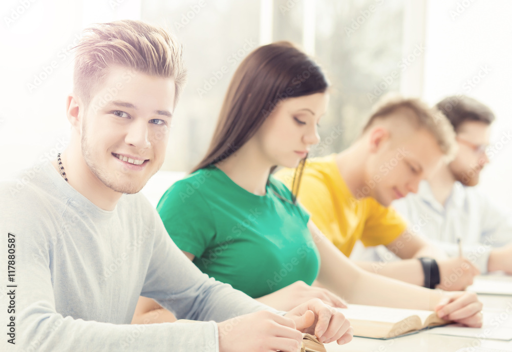 Young and smart students learning in a classroom Young and smart students learning in a classroom
