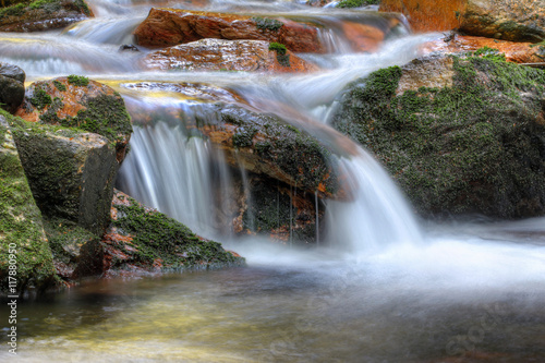 Long exposure of the water flowing over boulders