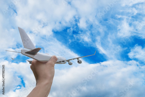 Airplane on hand white background on blue sky cloud