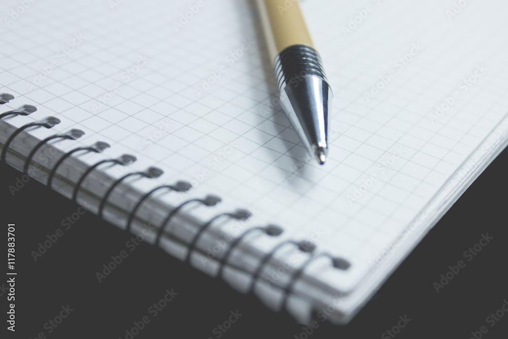 Pen and paper in the black background Pen and paper in the black background