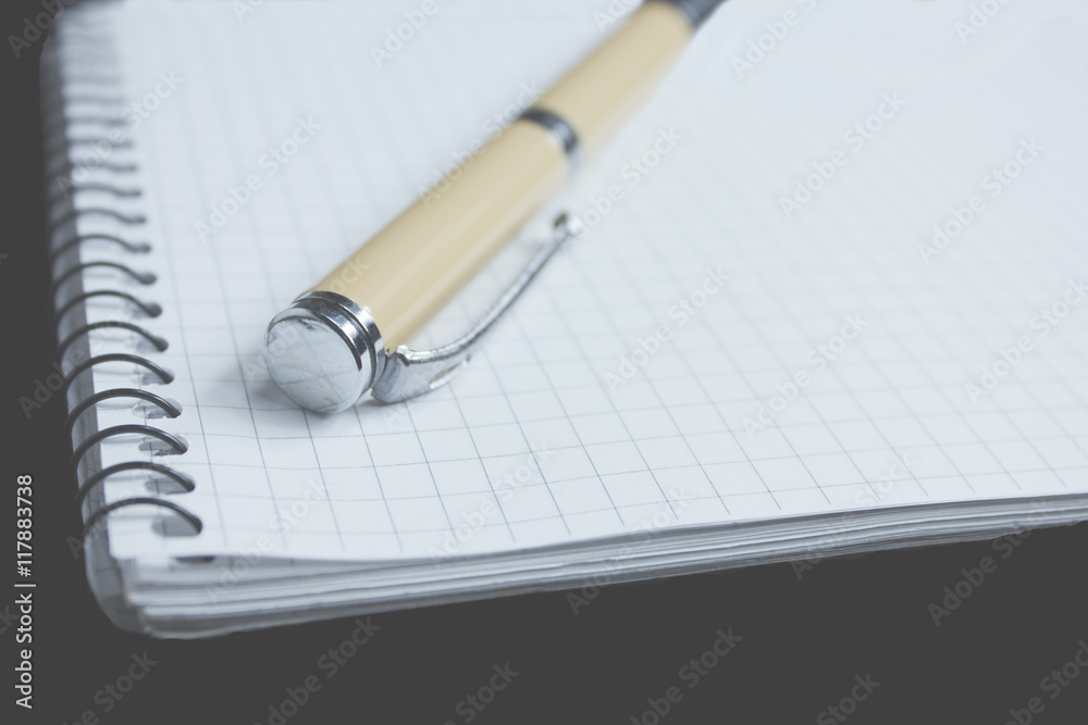 Pen and paper in the black background Pen and paper in the black background