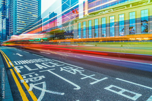 blurred traffic in downtown district,hong kong,china.Chinese characters on road are all traffic roadmarking.