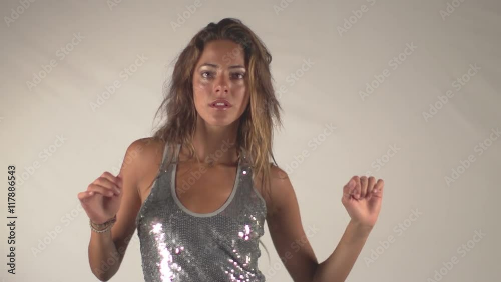 woman dances in a sparkly disco dress woman dances in a sparkly disco dress