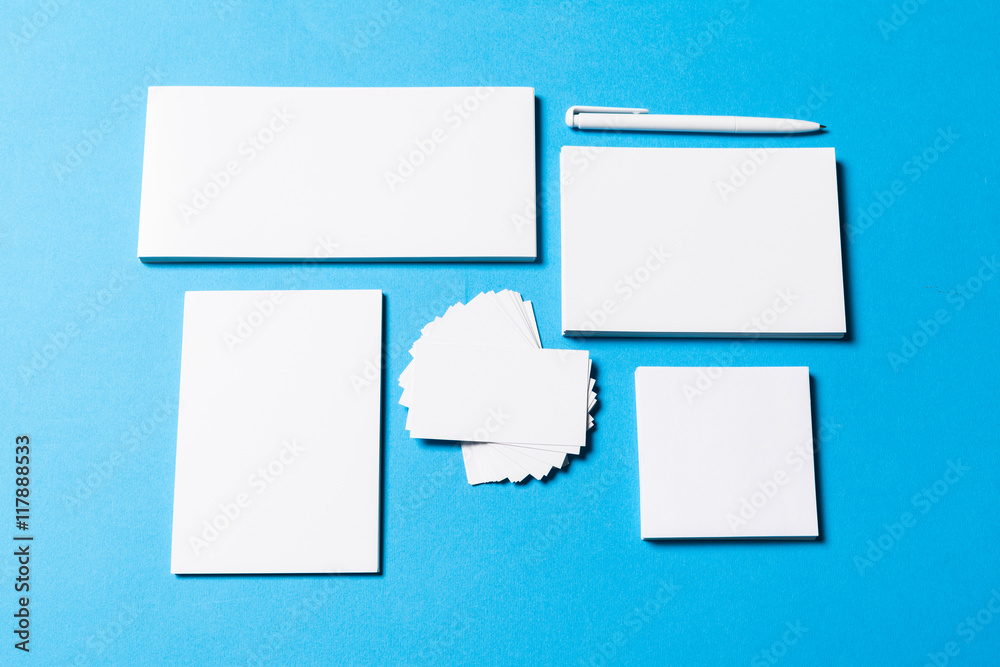 blank office objects organized for company presentation on blue paper background blank office objects organized for company presentation on blue paper background