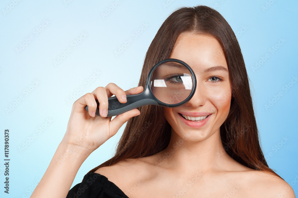 girl looking through a magnifying glass girl looking through a magnifying glass
