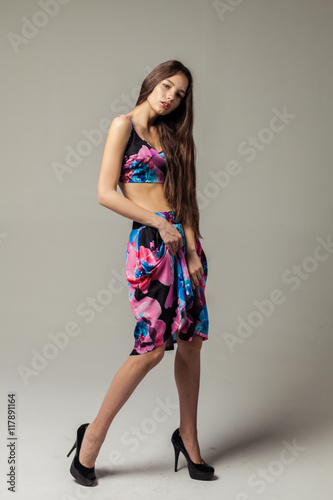 Full length portrait of a beautiful smiling woman posing isolated