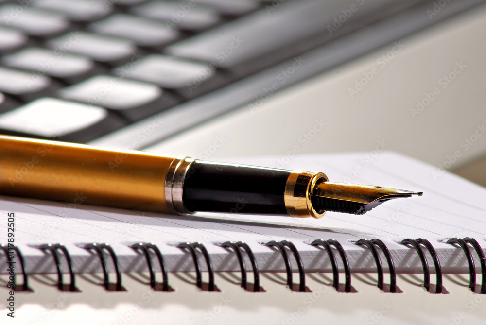 Fototapeta premium image of pen on keyboard background closeup