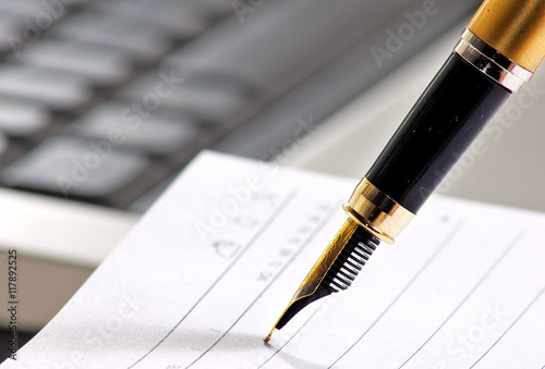 image of pen on keyboard background closeup