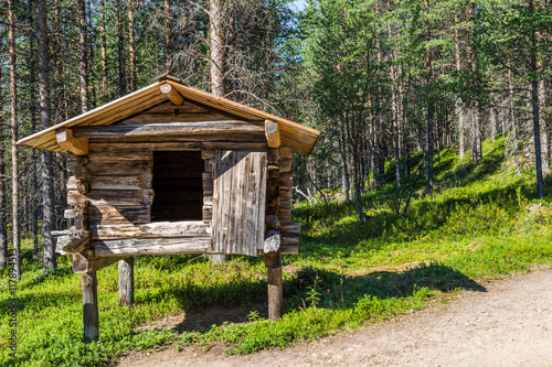 Small traditional  log house on wooden posts in which the Sami i