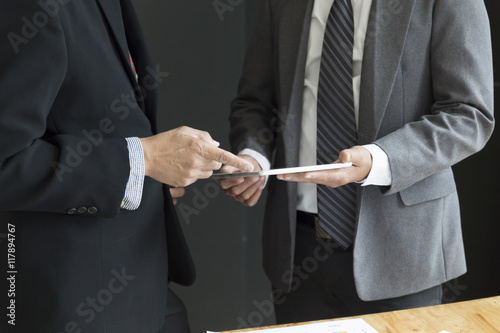 businessman in suit discuss with tablet and market analysis busi